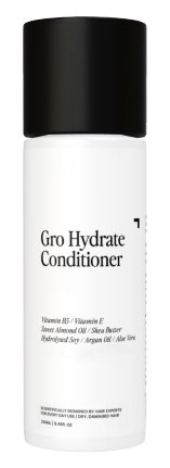 A white cylindrical bottle with a black cap labeled "Gro Clinics Hydrating Conditioner for Dry & Damaged Hair." The front text highlights ingredients such as Vitamin B5, Vitamin E, Sweet Almond Oil, Shea Butter, Hydrolyzed Soy, Argan Oil, and Aloe Vera. This nutrient-rich conditioner is perfect for dry and damaged hair.