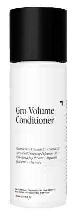 A white cylindrical bottle with a black cap labeled "Gro Clinics Volume Conditioner." This hydrating conditioner includes a range of ingredients such as Vitamin B5, Vitamin E, Almond Oil, Apricot Oil, Ginseng Root Extract, Hydrolyzed Soy Protein, Argan Oil, Castor Oil, and Aloe Vera.