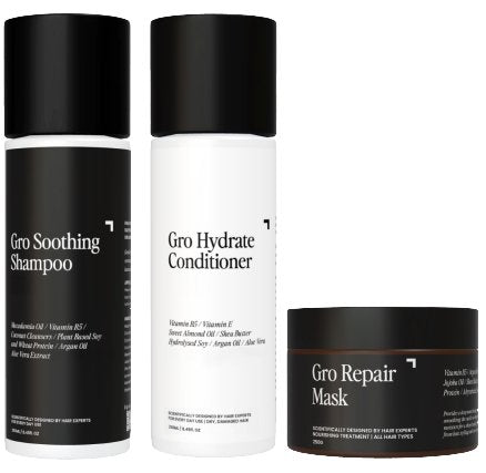 Image of three hair care products in sleek, minimalistic packaging from Gro Clinics. From left to right: Gro Soothing Shampoo in a tall black and white bottle, Gro Hydrate Conditioner in a matching bottle, and Gro Repair Hair Mask in a small black and white jar. Collectively known as the Hair Health Pack - Hydrate.