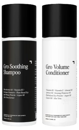 Two white cylindrical bottles with black caps from Gro Clinics. The left bottle in the Soothing Shampoo & Volume Conditioner Duo is labeled "Gro Soothing Shampoo," ideal for fine and thinning hair, featuring watermelon oil, vitamin B5, coconut cleansers, and more. The right bottle is labeled "Gro Volume Conditioner," enriched with vitamin B5, vitamin E, almond oil, and additional beneficial ingredients.